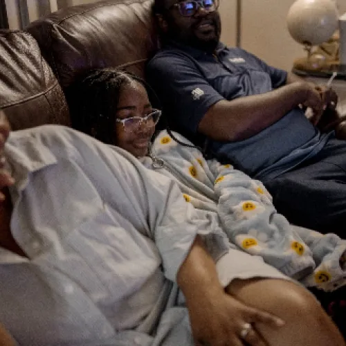 Two women and a girl in a sofa