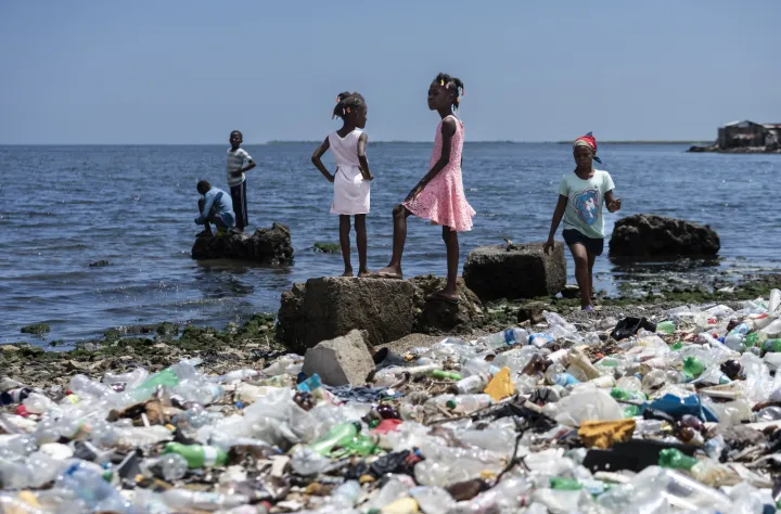 Girls on a sea shore waste