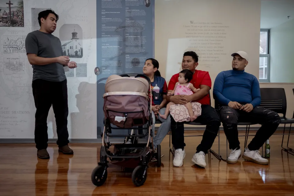 Nicaraguan migrant Miguel Flor&egrave;s translates for Latino families at Holy Trinity Church