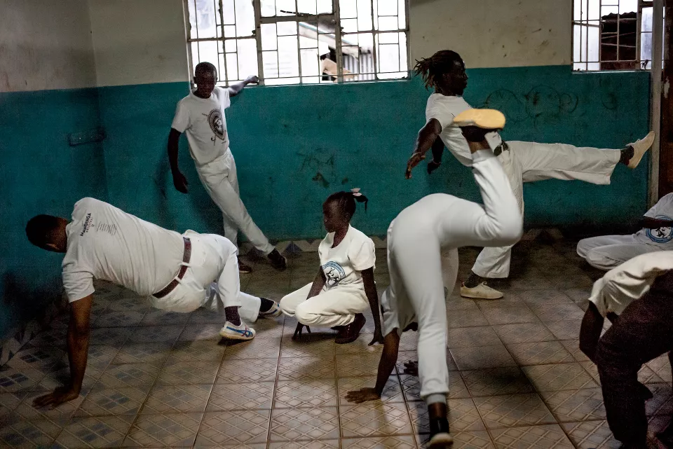 Youth in white clothing practicing acrobatic backflips
