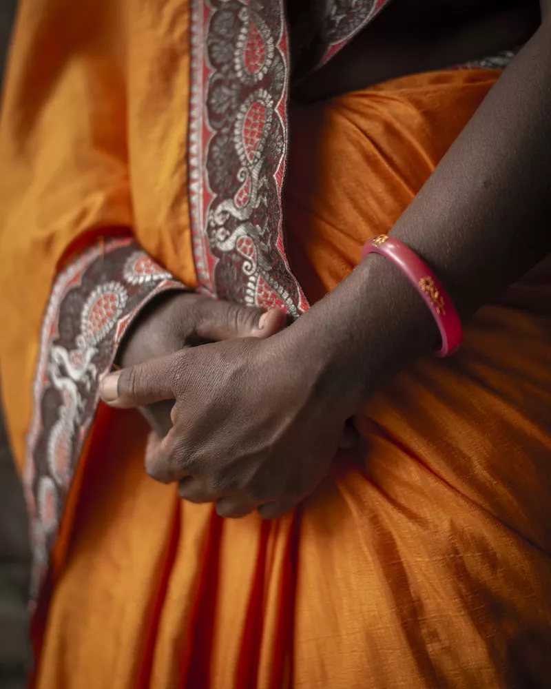 Close-up of dark-skinned hands clasped together