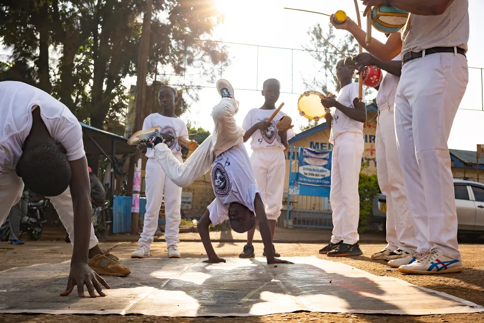 Outdoor acrobatic performance with youth performing backflips