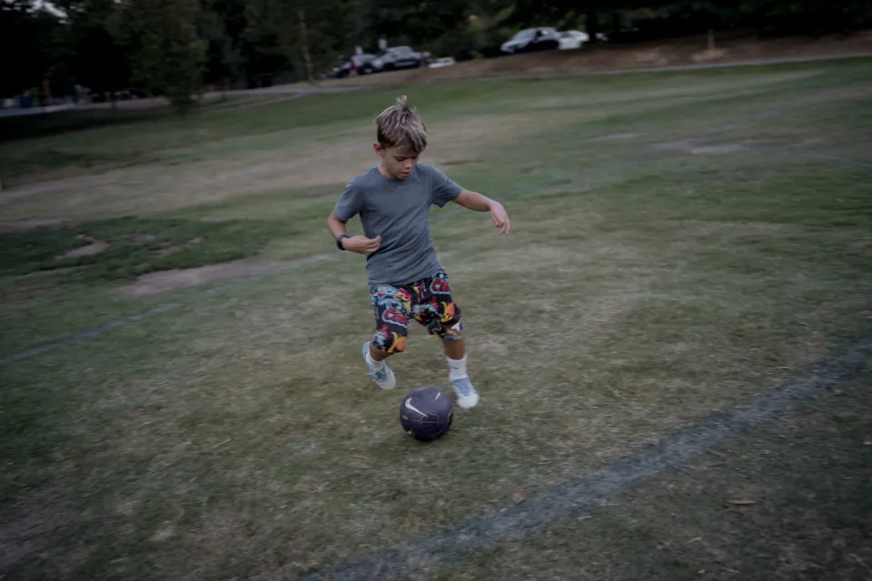 Sacha, 8, plays soccer in his Arlington neighborhood