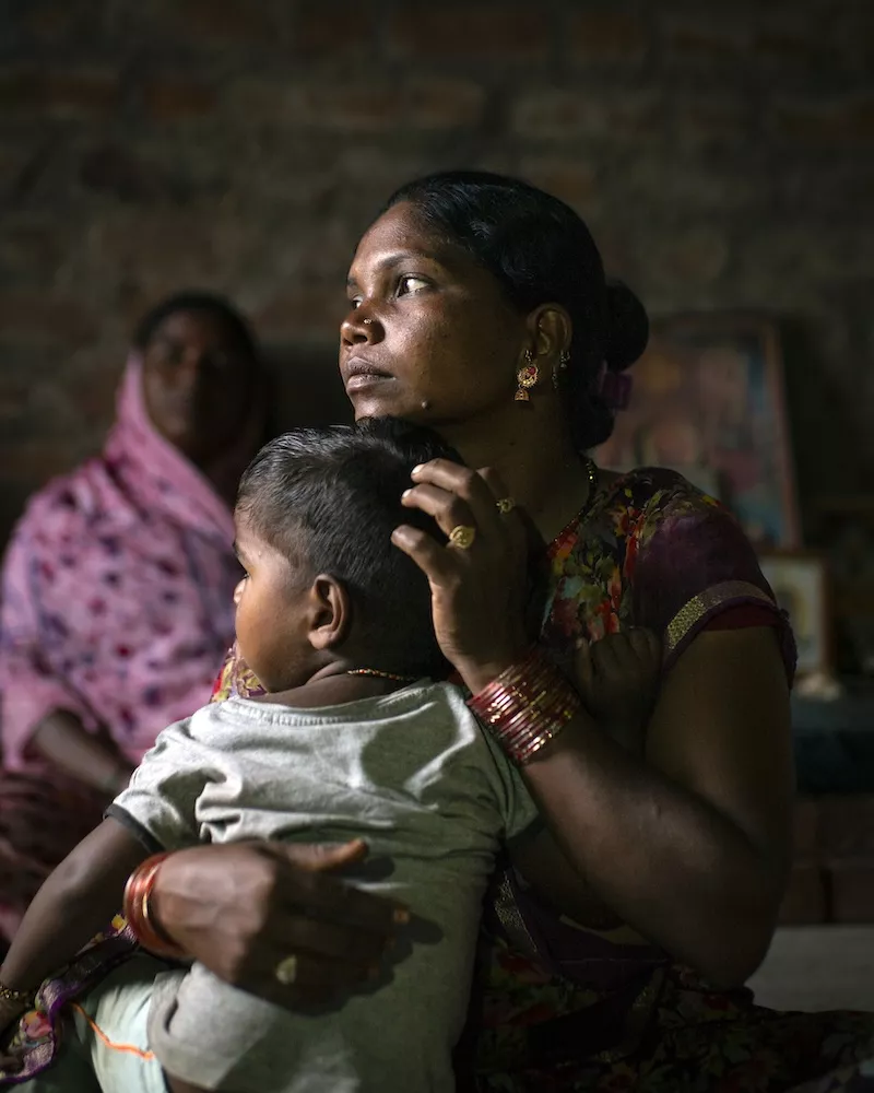 Woman holding young child in her arms