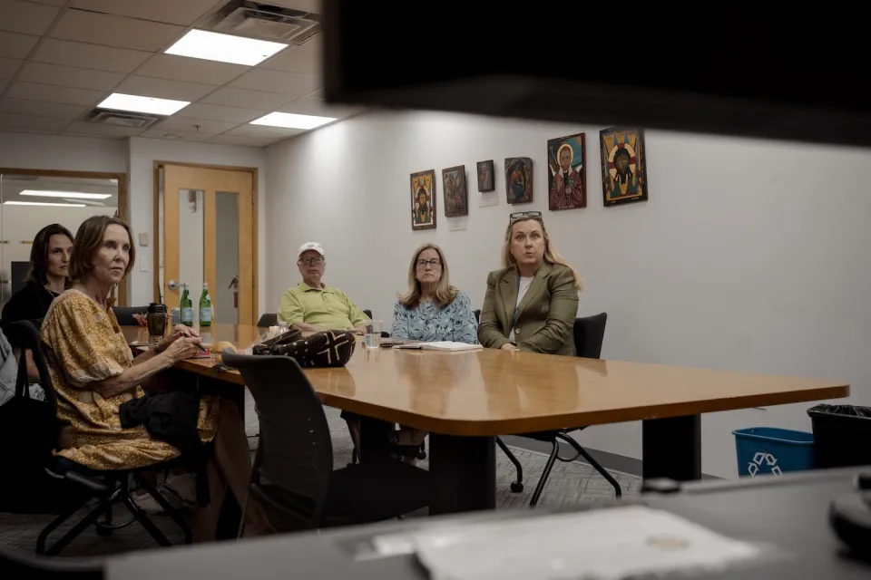 Volunteers assist Hakima during her final asylum hearing, streamed from Holy Trinity