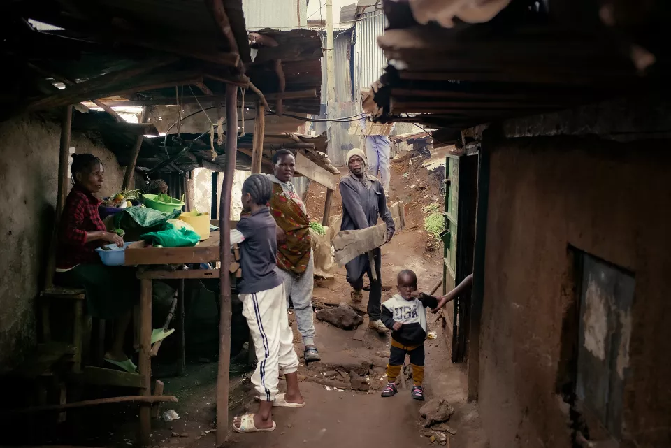 Narrow alleyway in an informal settlement with corrugated metal structures