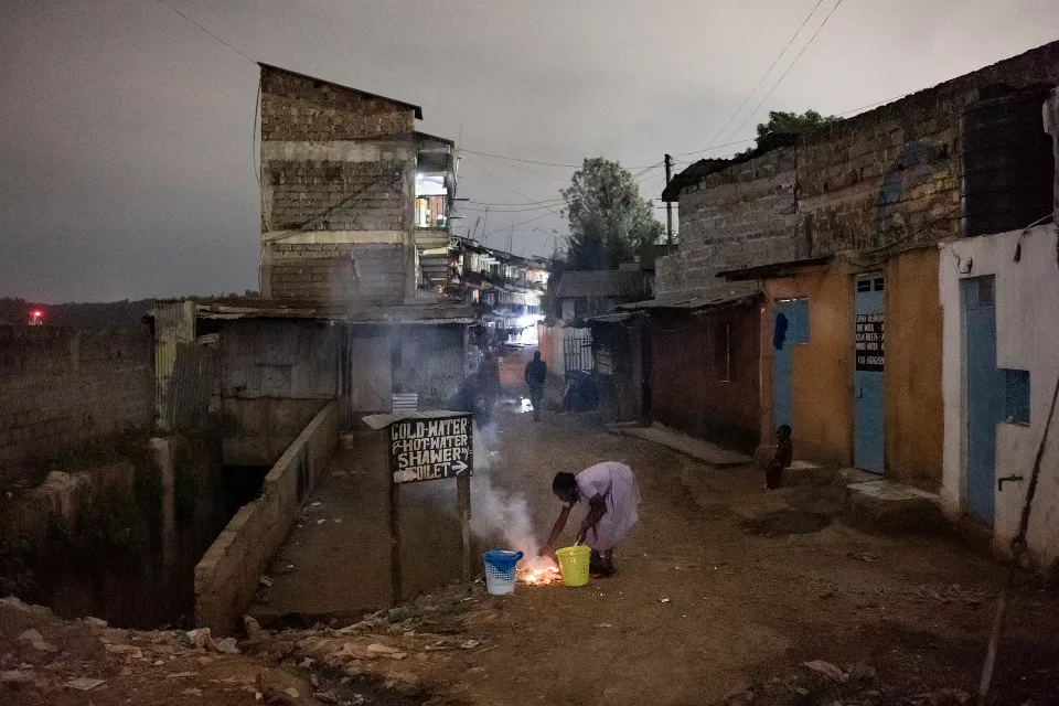Evening street scene in brick settlement buildings painted ochre and yellow