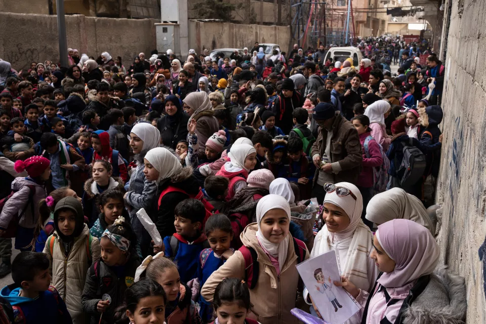 in the street, a swarm of schoolchildren aged around ten