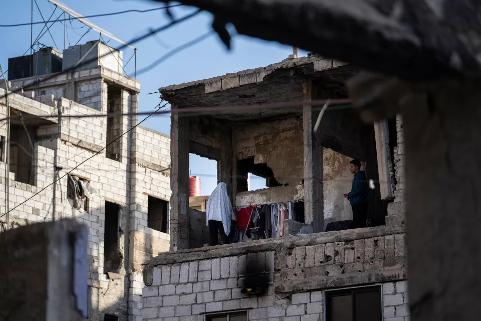 a balcony inhabited in a destroyed building, laundry drying